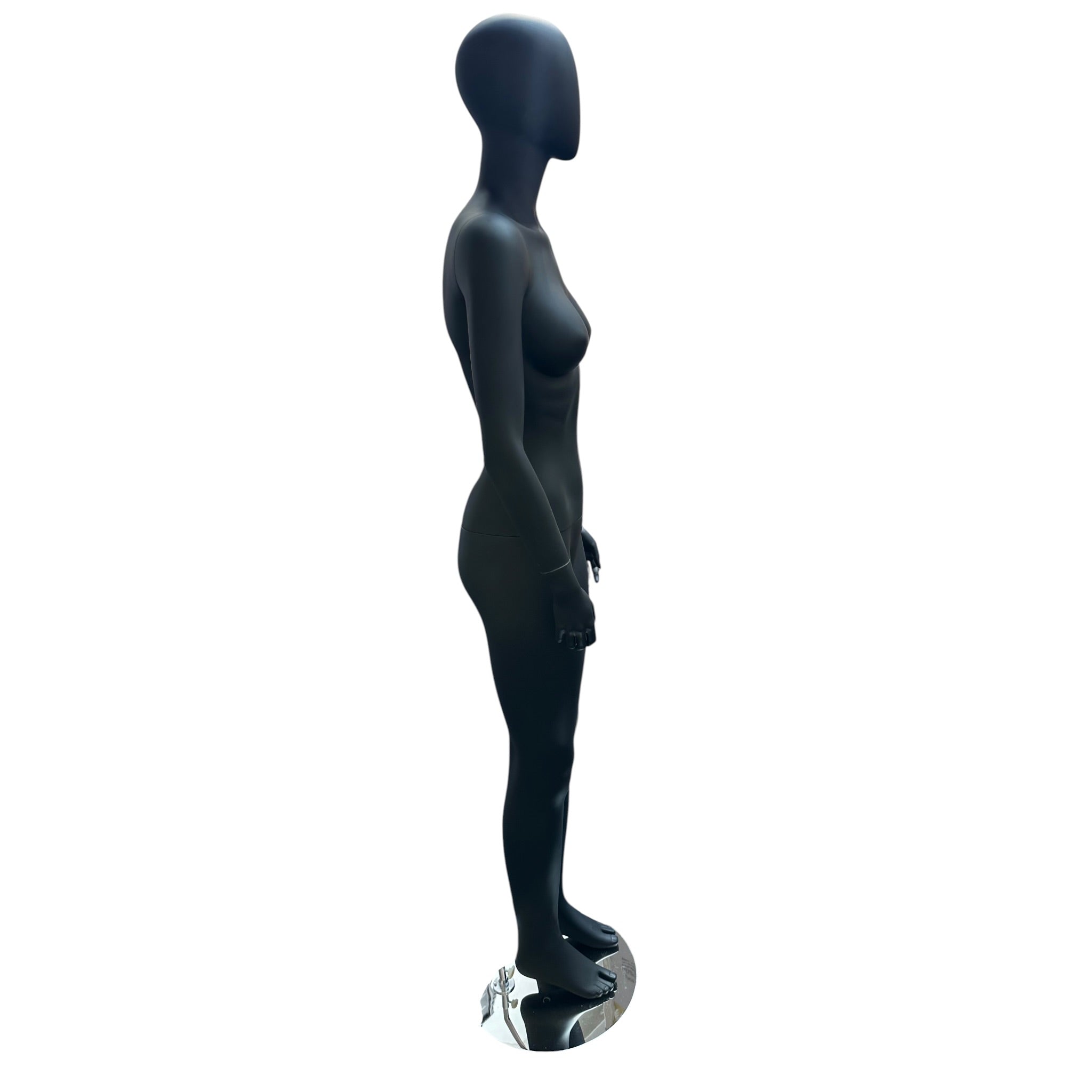 Faceless female mannequin. Black, matte with faceless head. Stands upright. Chrome base plate