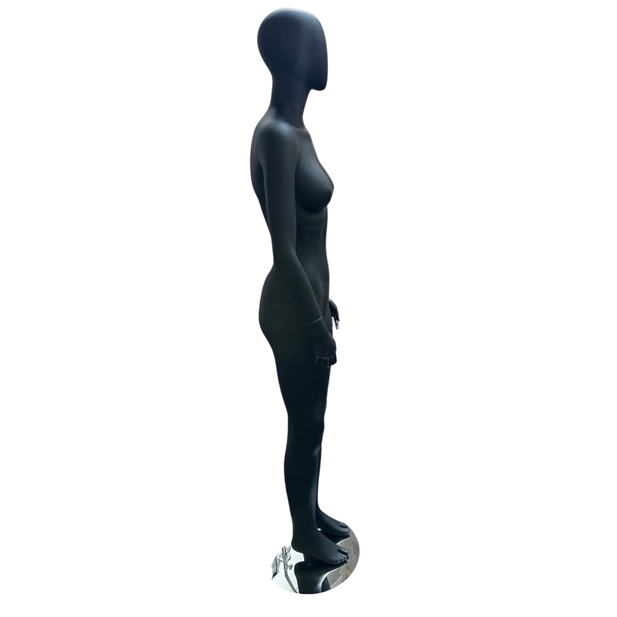 Faceless female mannequin. Black, matte with faceless head. Stands upright. Chrome base plate