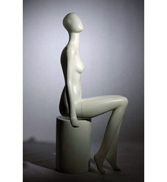 Faceless female mannequin. White, matte with faceless head. Glove hands. Seated